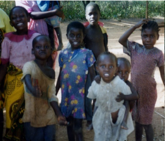 Children run to greet visitors